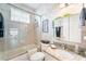 Bright bathroom with a shower-tub combo, granite countertop, and stylish decor at 708 Sandy Hills Ave, Tarpon Springs, FL 34689