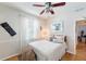 Relaxing bedroom offers a ceiling fan, ample natural light, and cozy furnishings at 708 Sandy Hills Ave, Tarpon Springs, FL 34689