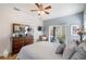 Comfortable bedroom featuring a ceiling fan, dresser, and sliding door to outdoor patio at 708 Sandy Hills Ave, Tarpon Springs, FL 34689