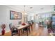 Inviting dining room with modern lighting, wood floors, and views to the entryway and living space at 708 Sandy Hills Ave, Tarpon Springs, FL 34689