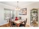 The dining room features a charming chandelier, bright window, and a display cabinet at 708 Sandy Hills Ave, Tarpon Springs, FL 34689
