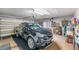 Clean garage with a black SUV, ample storage shelves, and functional garage door opener for convenience and organization at 708 Sandy Hills Ave, Tarpon Springs, FL 34689