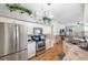 Updated kitchen with stainless steel appliances, granite countertops and wood-look tile flooring at 708 Sandy Hills Ave, Tarpon Springs, FL 34689