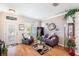 Inviting living room boasts wood floors, comfortable seating, and a bright window at 708 Sandy Hills Ave, Tarpon Springs, FL 34689