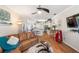 Open-concept living room and kitchen with wood floors and modern ceiling fan overlooking the breakfast bar at 708 Sandy Hills Ave, Tarpon Springs, FL 34689