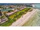 Aerial view of beachfront condos, tennis courts, a pool, and the Gulf of Mexico at 7480 Bayshore Dr # 402, Treasure Island, FL 33706