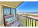 Balcony view showcasing comfortable outdoor seating with ocean views beyond the railing at 7480 Bayshore Dr # 402, Treasure Island, FL 33706