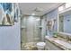 Bathroom featuring glass enclosed shower, granite countertop vanity, and updated fixtures at 7480 Bayshore Dr # 402, Treasure Island, FL 33706