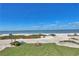 Expansive beach view featuring bright blue skies, palm trees, and lush greenery from an elevated position on a sunny day at 7480 Bayshore Dr # 402, Treasure Island, FL 33706