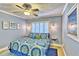 Inviting bedroom with shuttered window, coastal decor, and hardwood floors at 7480 Bayshore Dr # 402, Treasure Island, FL 33706