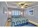 Serene bedroom with shuttered windows, sconces, side tables and blue-themed decor at 7480 Bayshore Dr # 402, Treasure Island, FL 33706