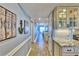 Hallway leading to the living area, with a kitchen to the side and decor with a beach theme at 7480 Bayshore Dr # 402, Treasure Island, FL 33706