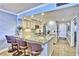 Modern kitchen with granite countertops, stainless steel appliances, and breakfast bar seating at 7480 Bayshore Dr # 402, Treasure Island, FL 33706