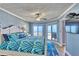 Comfortable bedroom featuring a king-sized bed, stylish decor, and sliding doors leading to a private balcony at 7480 Bayshore Dr # 402, Treasure Island, FL 33706