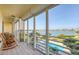Screened balcony with serene water views, comfortable seating, and a calming atmosphere, perfect for relaxing at 7872 Sailboat Key S Blvd # 306, South Pasadena, FL 33707