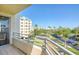 Scenic balcony view overlooking lush greenery, palm trees, and community buildings at 7872 Sailboat Key S Blvd # 306, South Pasadena, FL 33707