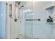 Bright bathroom with a glass shower featuring modern fixtures and gray tile flooring at 7872 Sailboat Key S Blvd # 306, South Pasadena, FL 33707