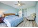 Inviting bedroom with wood floors, ceiling fan, bedside tables, and comfortable chair at 7872 Sailboat Key S Blvd # 306, South Pasadena, FL 33707
