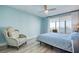 Bright bedroom with a chair, ceiling fan, and a large window showcasing waterfront views at 7872 Sailboat Key S Blvd # 306, South Pasadena, FL 33707