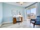Bright bedroom featuring a desk, modern decor and slider door access to a sunny balcony at 7872 Sailboat Key S Blvd # 306, South Pasadena, FL 33707