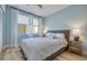Relaxing bedroom with wood floors, ceiling fan, and comfortable bed at 7872 Sailboat Key S Blvd # 306, South Pasadena, FL 33707