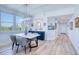 Bright dining area featuring a marble table, modern lighting, and a hallway view at 7872 Sailboat Key S Blvd # 306, South Pasadena, FL 33707