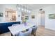 Stylish dining area with a marble table, blue cabinets, and kitchen views at 7872 Sailboat Key S Blvd # 306, South Pasadena, FL 33707