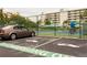 Onsite EV charging stations for electric vehicles at this community, with tennis court in background at 7872 Sailboat Key S Blvd # 306, South Pasadena, FL 33707