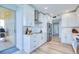 Bright kitchen featuring sleek appliances, white cabinets, and access to the balcony with outside view at 7872 Sailboat Key S Blvd # 306, South Pasadena, FL 33707