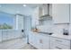 Bright kitchen featuring white cabinets, a modern backsplash, stainless steel appliances, and a picturesque window view at 7872 Sailboat Key S Blvd # 306, South Pasadena, FL 33707