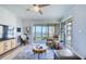 Cozy living room with comfortable seating, balcony access, and scenic waterfront views at 7872 Sailboat Key S Blvd # 306, South Pasadena, FL 33707