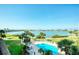 Refreshing pool with stunning water views, palm trees, and comfortable lounging areas, ideal for sunny days at 7872 Sailboat Key S Blvd # 306, South Pasadena, FL 33707