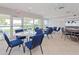 Bright recreation room with tile floors, tables with chairs, and views of the outside at 7872 Sailboat Key S Blvd # 306, South Pasadena, FL 33707