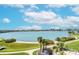 Expansive water views featuring clear blue skies, calm waters, and lush green landscaping with palm trees at 7872 Sailboat Key S Blvd # 306, South Pasadena, FL 33707