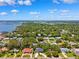 Scenic aerial view of a neighborhood with lush green trees and waterfront access in the distance at 8231 31St N Ter, St Petersburg, FL 33710