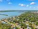 Breathtaking aerial view showcasing waterfront homes amidst lush greenery under a vibrant sky with scattered clouds at 8231 31St N Ter, St Petersburg, FL 33710