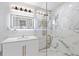 Elegant bathroom featuring a marble-tiled shower with glass door, chic vanity, and modern fixtures at 8231 31St N Ter, St Petersburg, FL 33710