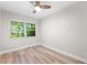 Serene bedroom featuring a neutral palette, wood-look floors, ample light, and a contemporary ceiling fan at 8231 31St N Ter, St Petersburg, FL 33710