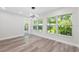 Bright dining area with modern light fixture and large windows overlooking lush greenery at 8231 31St N Ter, St Petersburg, FL 33710
