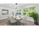 Dining room with a modern table, stylish chairs, contemporary lighting fixture, and views of lush greenery at 8231 31St N Ter, St Petersburg, FL 33710