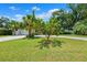Well-manicured front lawn with a small fruit tree near a single story home with a paver driveway at 8231 31St N Ter, St Petersburg, FL 33710