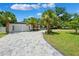 Beautiful home featuring a two-car garage, lush landscaping, and a paver driveway at 8231 31St N Ter, St Petersburg, FL 33710