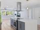 Kitchen boasts a large center island with oven, stainless steel range hood, and backyard views at 8231 31St N Ter, St Petersburg, FL 33710