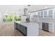 Bright kitchen features a large center island, stainless steel appliances, modern cabinetry, and stylish countertops at 8231 31St N Ter, St Petersburg, FL 33710