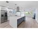 Open kitchen features a large center island, stainless steel appliances, modern cabinetry, and backyard views at 8231 31St N Ter, St Petersburg, FL 33710