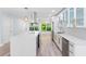 Bright kitchen boasts a large center island, stainless steel appliances, modern white cabinetry, and stylish countertops at 8231 31St N Ter, St Petersburg, FL 33710