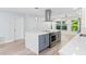 Kitchen boasts a large center island with oven, stainless steel range hood, and backyard views at 8231 31St N Ter, St Petersburg, FL 33710