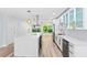 Bright kitchen boasts a large center island, stainless steel appliances, modern white cabinetry, and stylish countertops at 8231 31St N Ter, St Petersburg, FL 33710