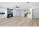 Open floor plan view of living room, fireplace, kitchen, and light wood floors at 8231 31St N Ter, St Petersburg, FL 33710