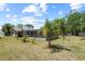 Backyard featuring pool in screened enclosure, and lush green lawn at 8317 Needles Dr, Hudson, FL 34667